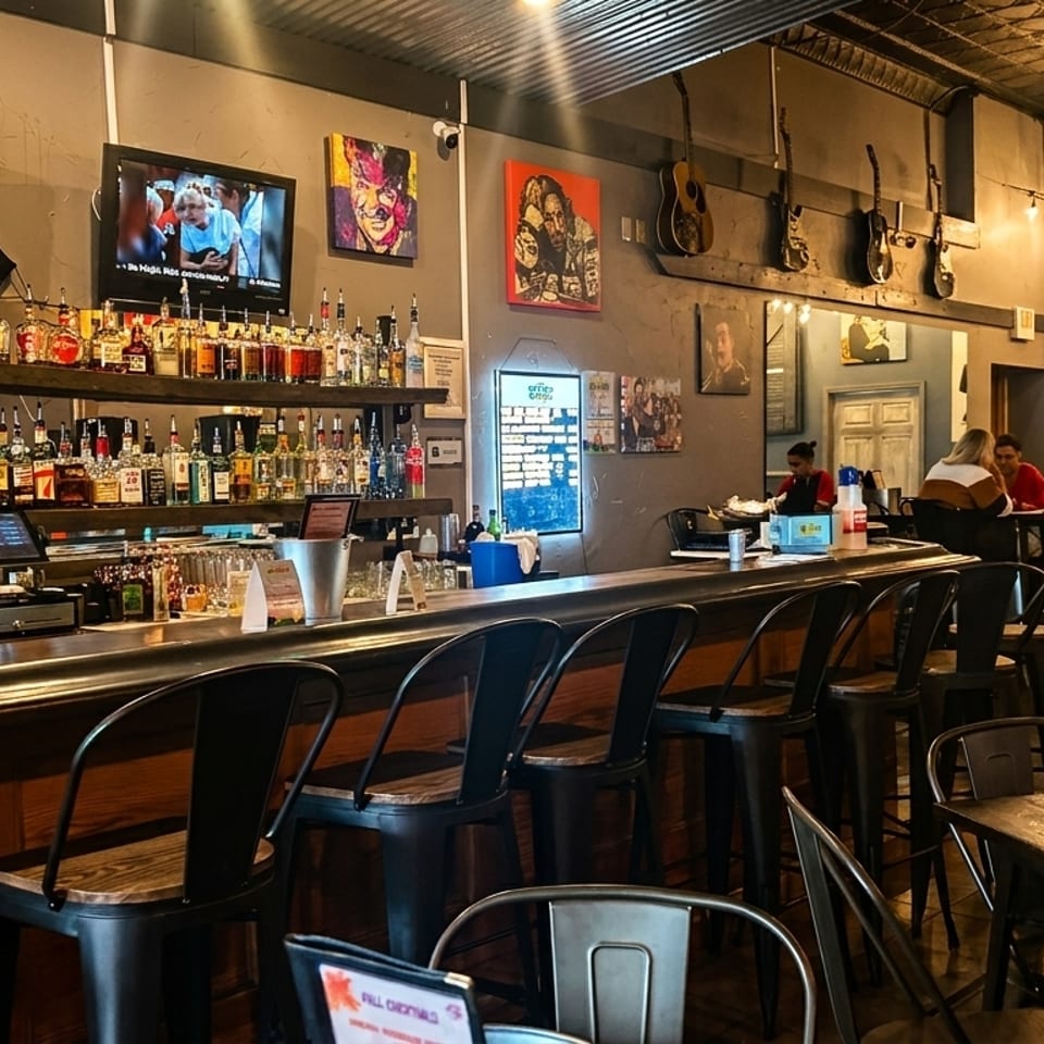 A lively bar area with a fully stocked bar, bar stools, and patrons enjoying drinks and conversation.